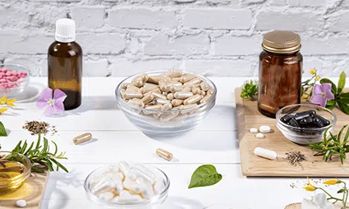Assorted dietary supplement containers and capsules representing small, light consumable products