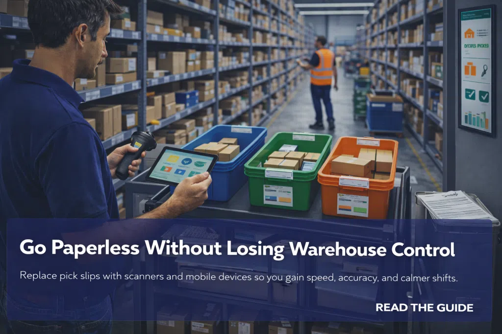 Picker uses a tablet and scanner at a cart of color totes in a warehouse aisle while another worker scans boxes in the background.